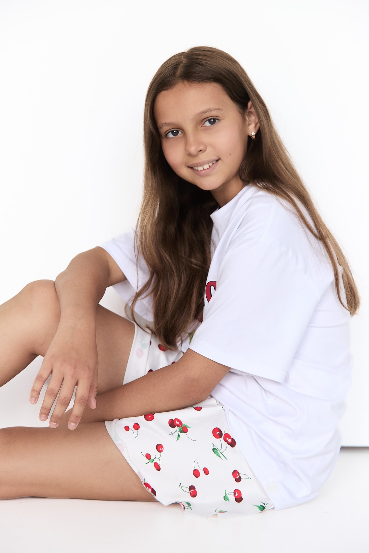Kira seated in a casual commercial fashion pose