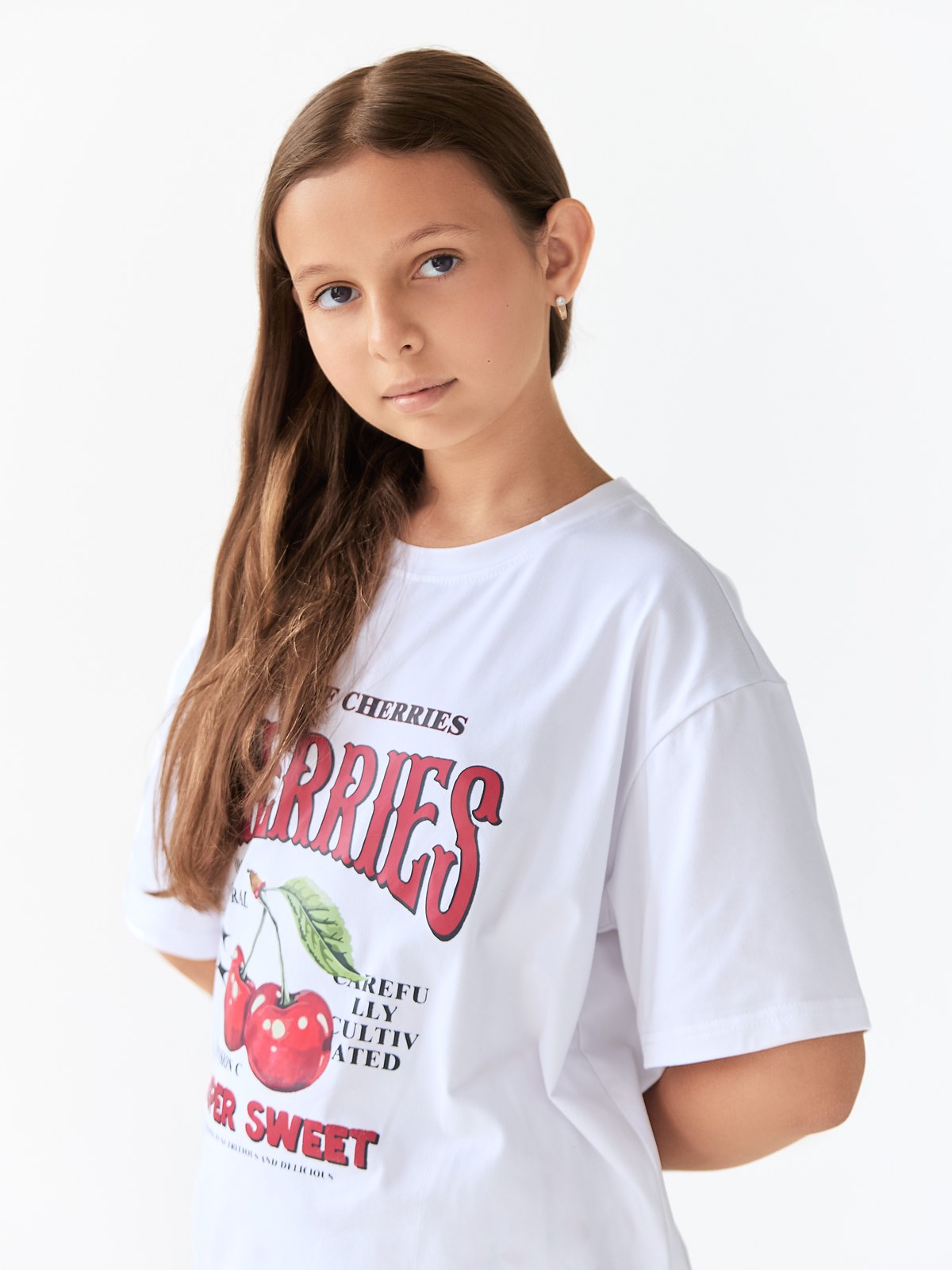 Confident studio portrait in a white graphic T-shirt