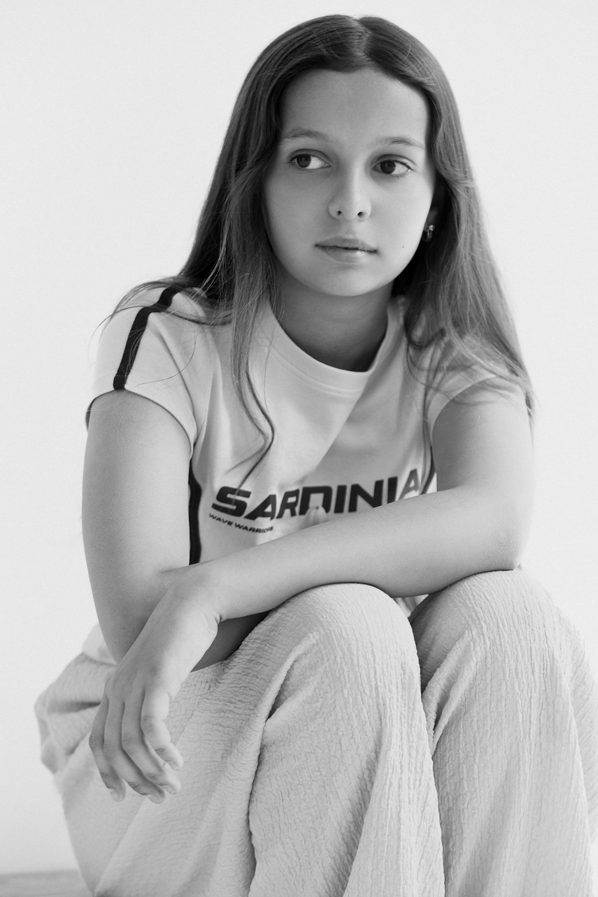 Black-and-white seated editorial portrait