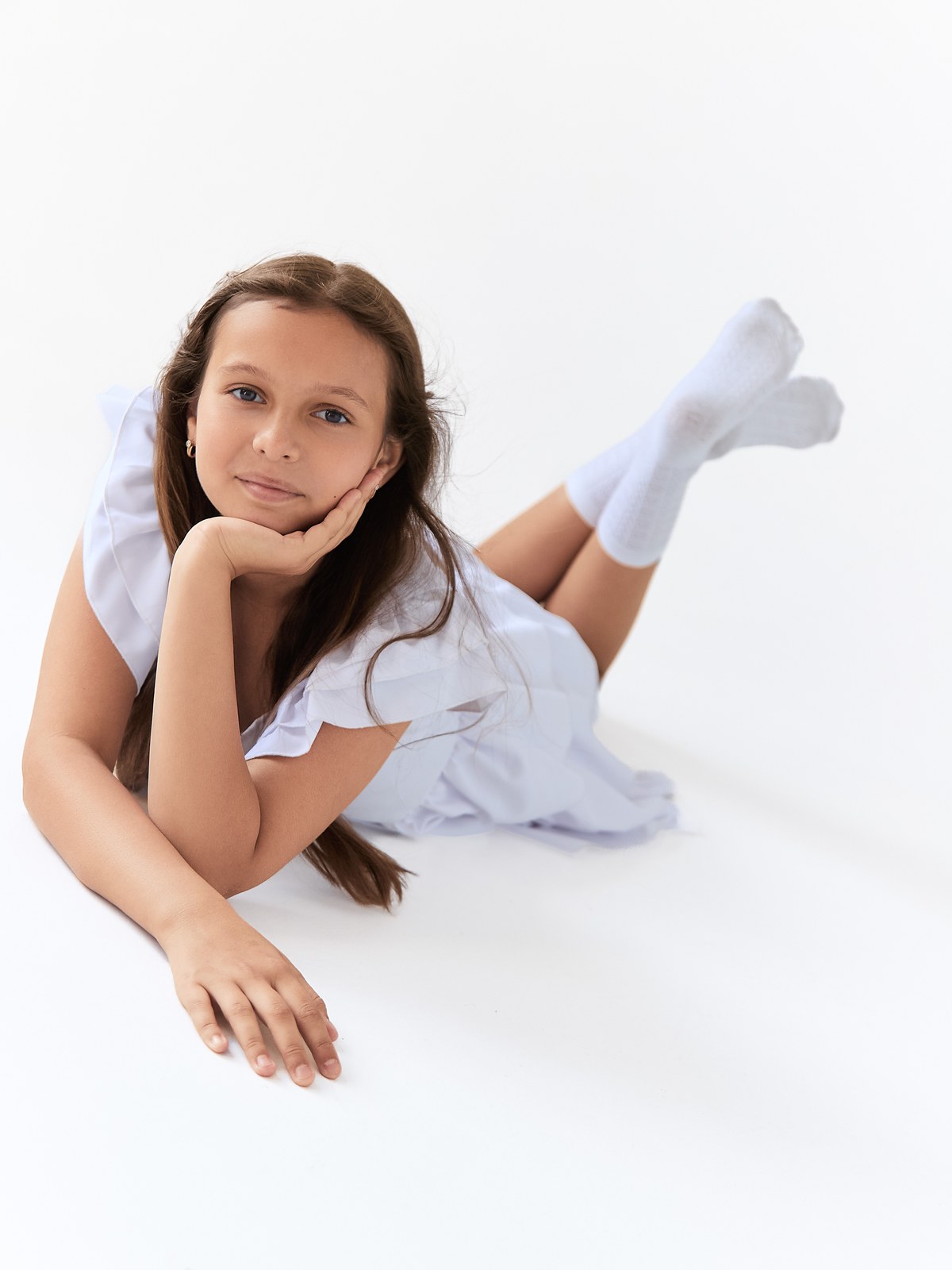 Soft floor portrait in a white dress