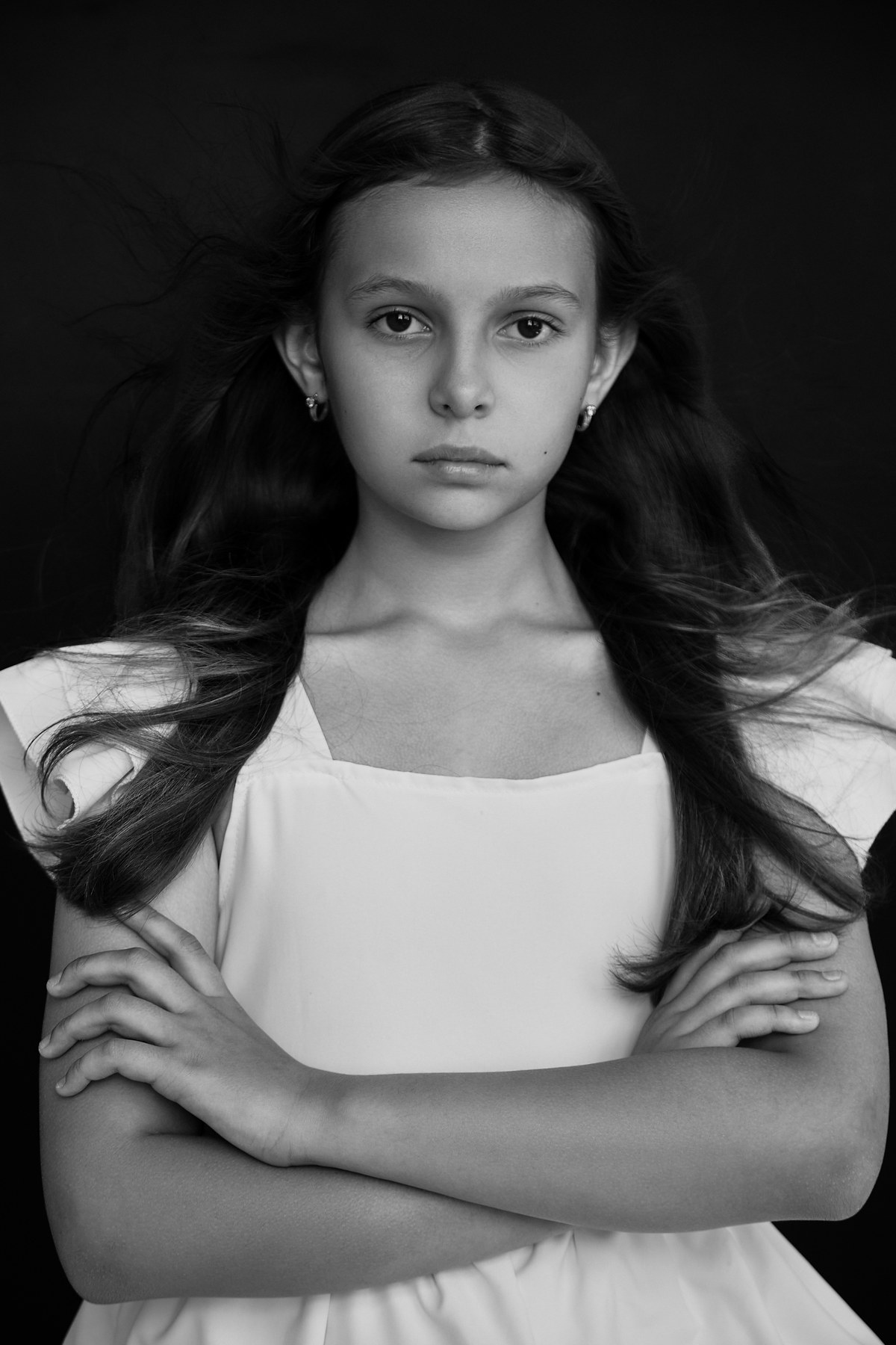 Black-and-white studio portrait with a direct gaze