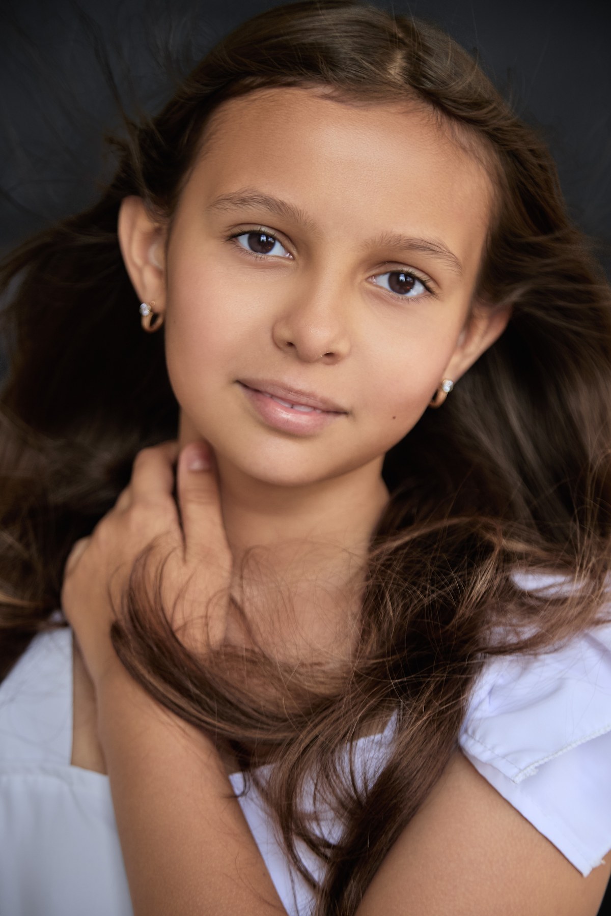 Close editorial portrait of Kira against a dark background